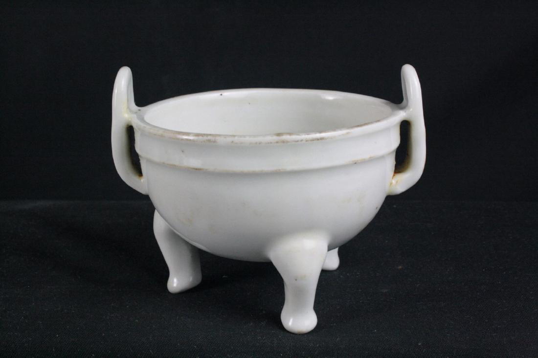 Chinese White Glazed Porcelain Censer: Ming Dynasty Chinese white glazed tripod porcelain censer; flanked with handle; unglazed base; H: 9 cm, W: 11 cm