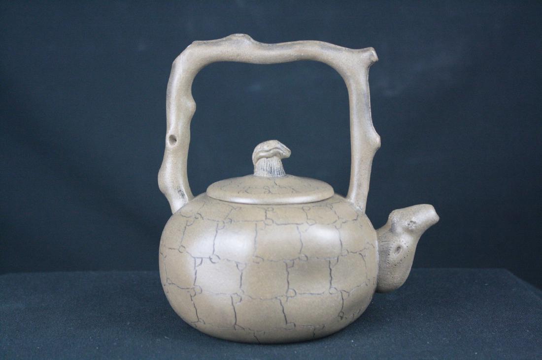 Chinese Zisha Teapot: Chinese zisha teapot; of circular form; with tree branch handle; base with mark; H: 15 cm, W: 15 cm