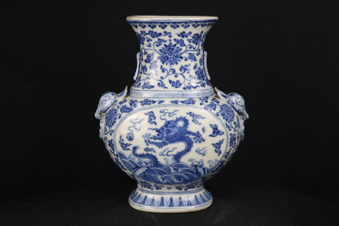 Chinese Blue and White Porcelain Vase: Chinese blue and white porcelain vase; flanked with beast shape handle and ring; painted with two dragon panel; all reserved on scrolling floral; six character Qianlong mark on base; H: 25 cm, W: 22 c
