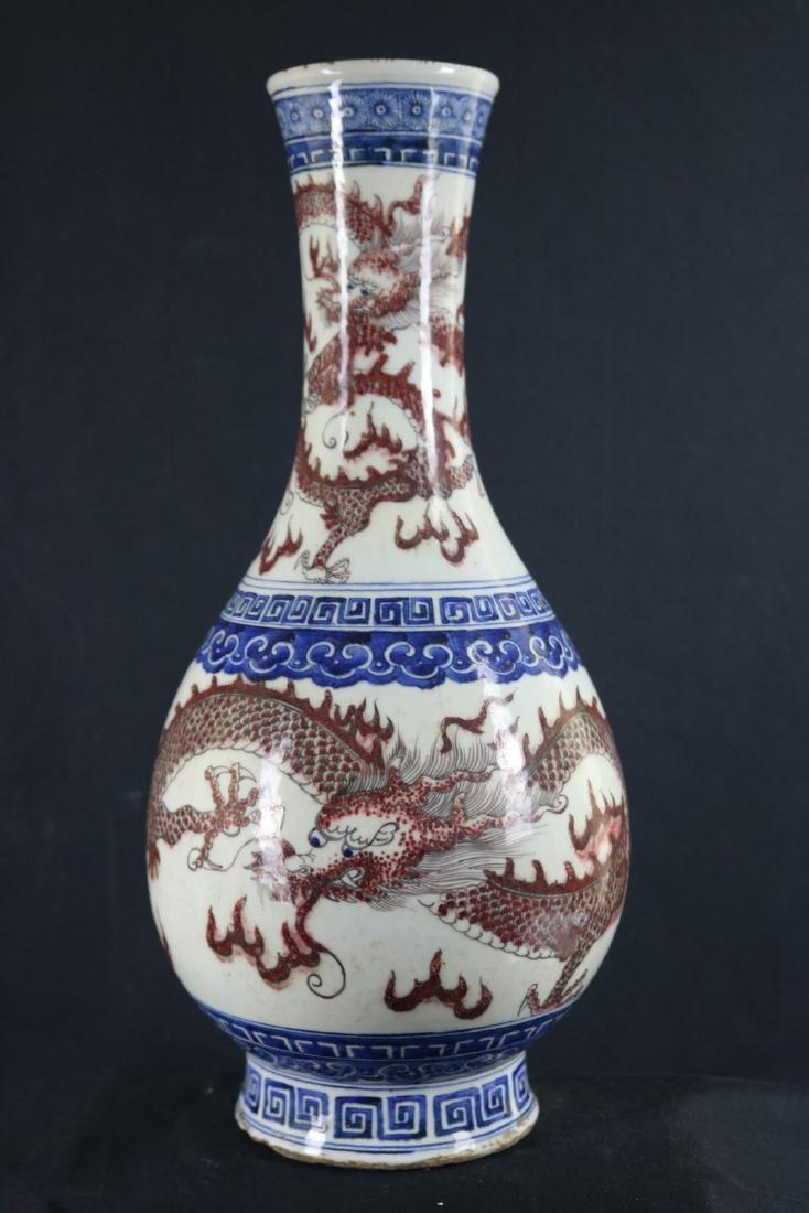 Chinese Blue, Red and White Porcelain Vase: Chinese blue, red and white porcelain vase; painted with dragon; six character Kangxi mark on base; H: 44 cm, W: 20 cm