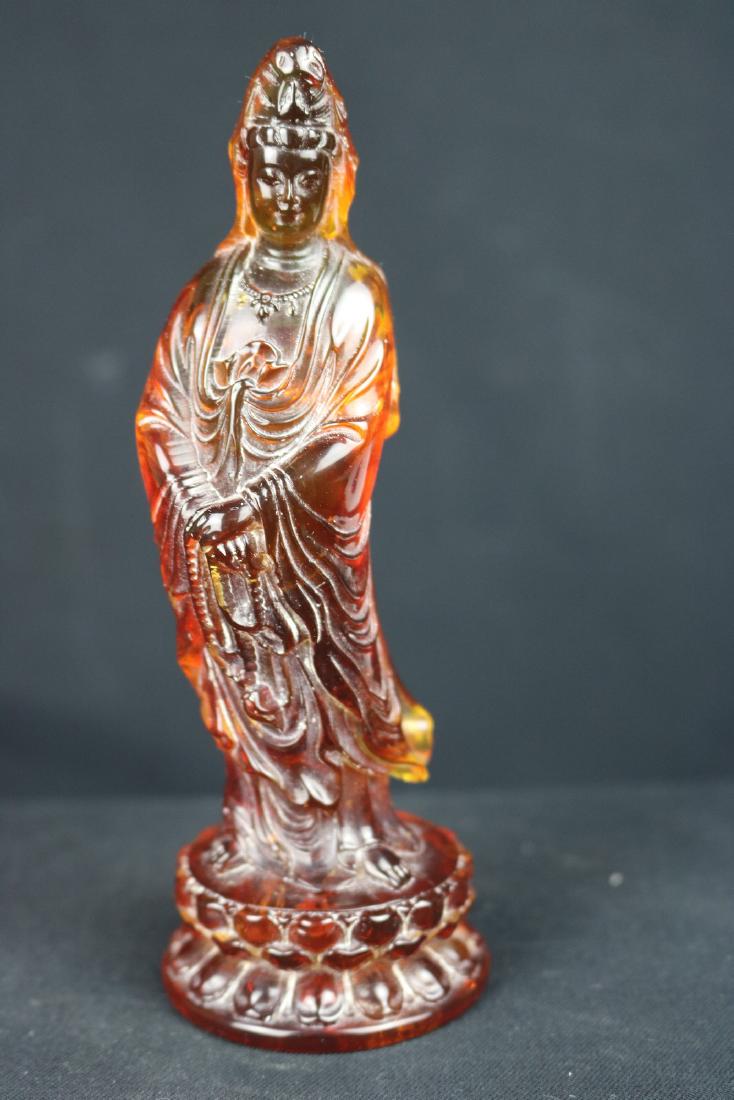 Chinese Carved Amber Guan Yin: Chinese carved amber Guan Yin; of standing on top of lotus mount; both hands holding an necklace; H: 15 cm, W: 5.5 cm