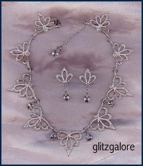 Franklin Mint Nightfire Set: From the Franklin Mint in 1987 this set is called Nightfire. It is a stunning necklace and earring set. Necklace adjusts up to about 17" and is 1 1/4" wide. Earrings are for pierced ears and