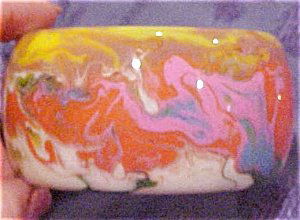Sobral multi colored resin bangle: Sobral multi colored resin bangle. This is a contemporary bangle. orange, blue, pink, green, fuschia and yellow. It is 2" wide and the inside opening is 2 1/2". Dealer: Thanks For The Memori
