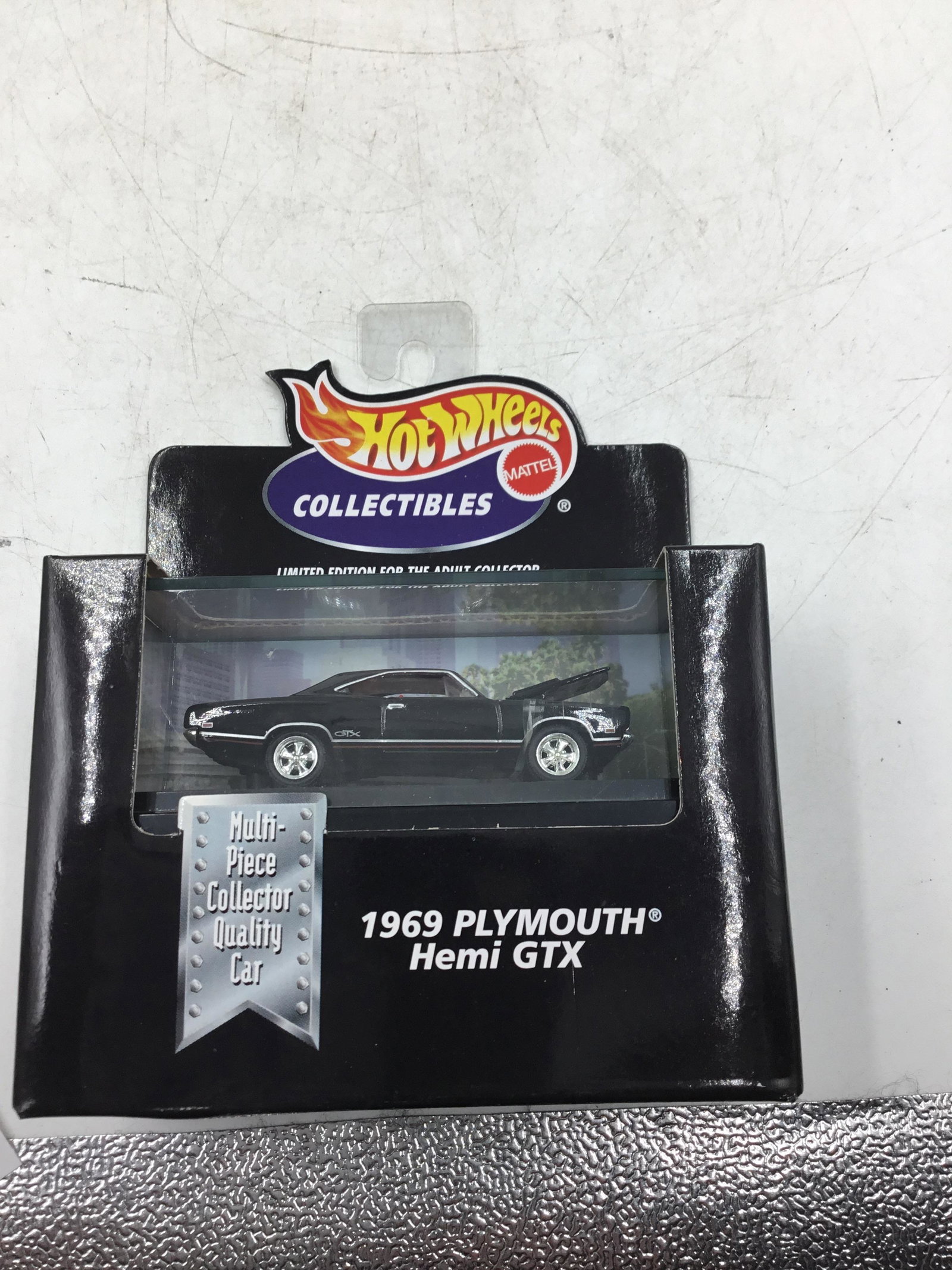 1998 Hot Wheels 1:64 scale Plymouth Hemi GTX: 1969 Plymouth Hemi GTX Black body hood opens Still in box with factory sealed but it has three fingerprints of a clumsy worker I suppose this but make it special. #26798