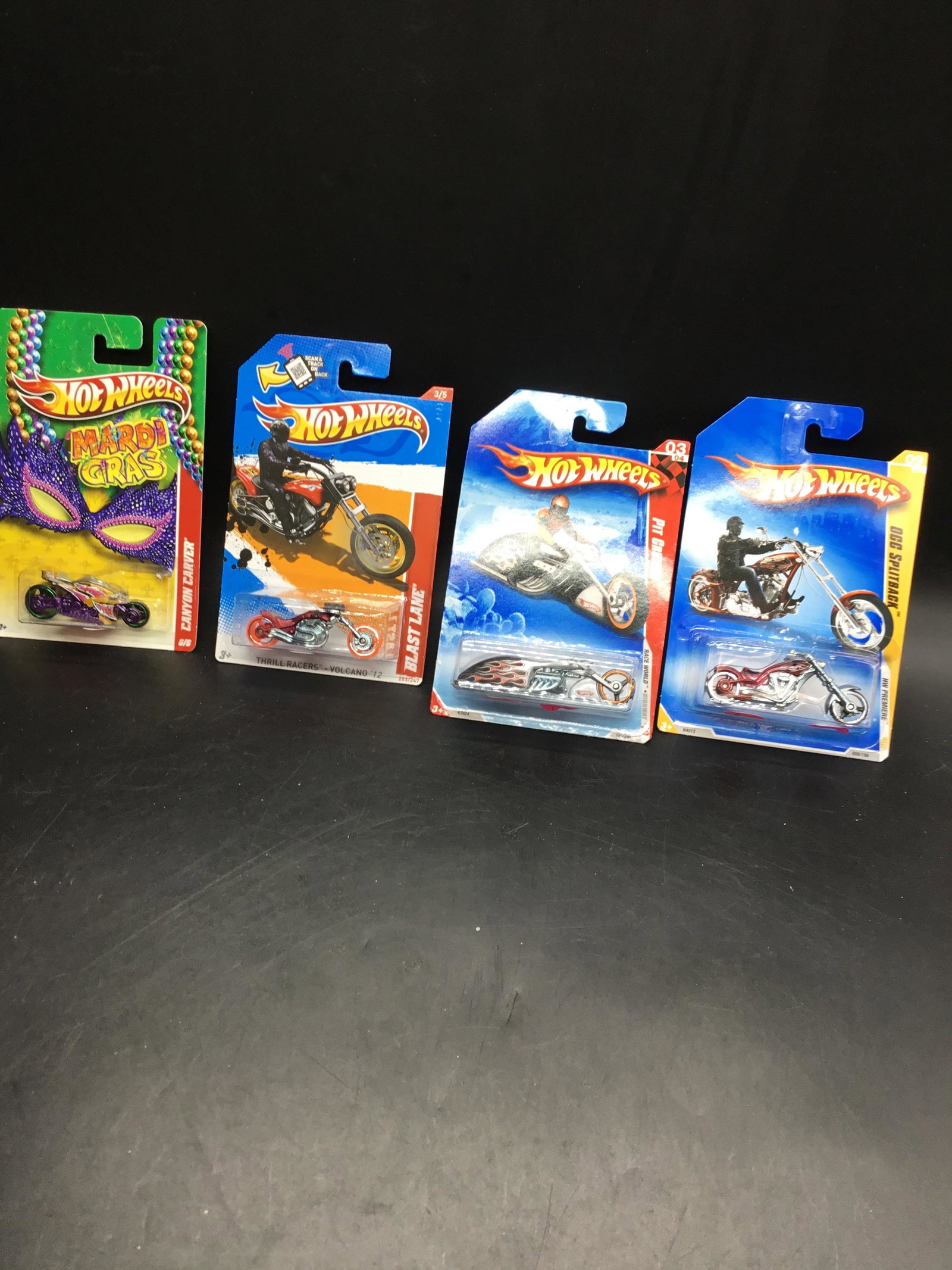 4 cars Hot Wheels Blast Pack Carver: Hot wheels set includes for two wheelers include Kroger‘s exclusive Mardi Gras Canyon carver and hot wheels Premier OCC back race world highway pit cruiser and thrill racer Volcano.#009 OCC Split Ba