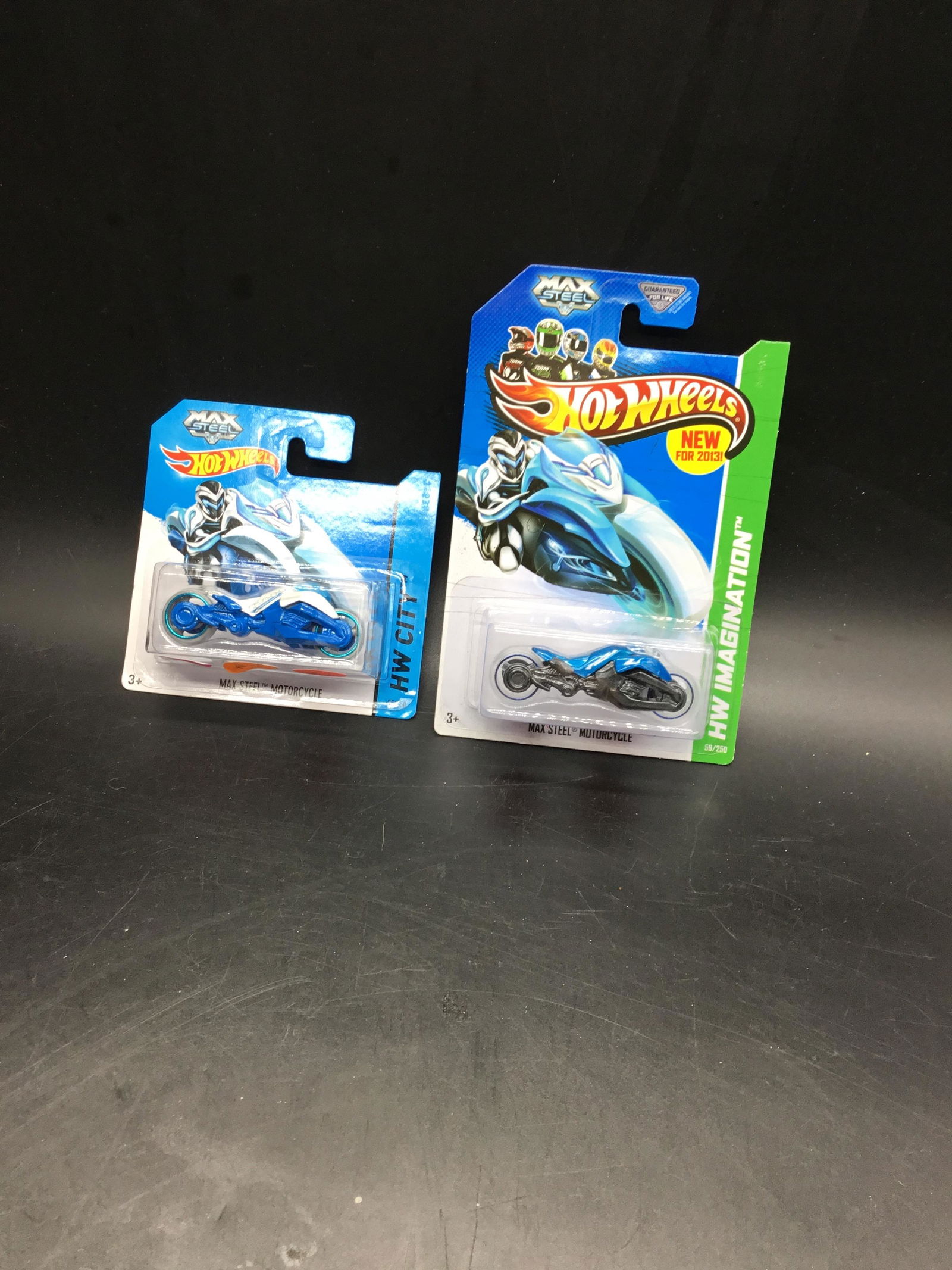 Set of two Hot Wheels Max Steel: #59 Max steel motorcycle blue and #85 Max steel motorcycle white on short card.
