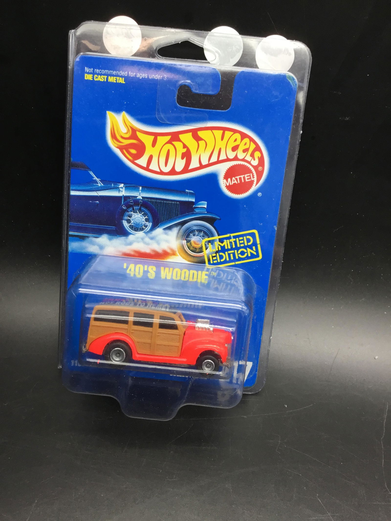 #217 is a 1994 Hot Wheels 40s Woodie: #217 is a 1994 Hot Wheels 40s Woodie. Is a limited edition Early Times 94 hot rods to helmet example. It has a real rider and it is very hard to find Dayglo red looks pink to me gray hubbs.