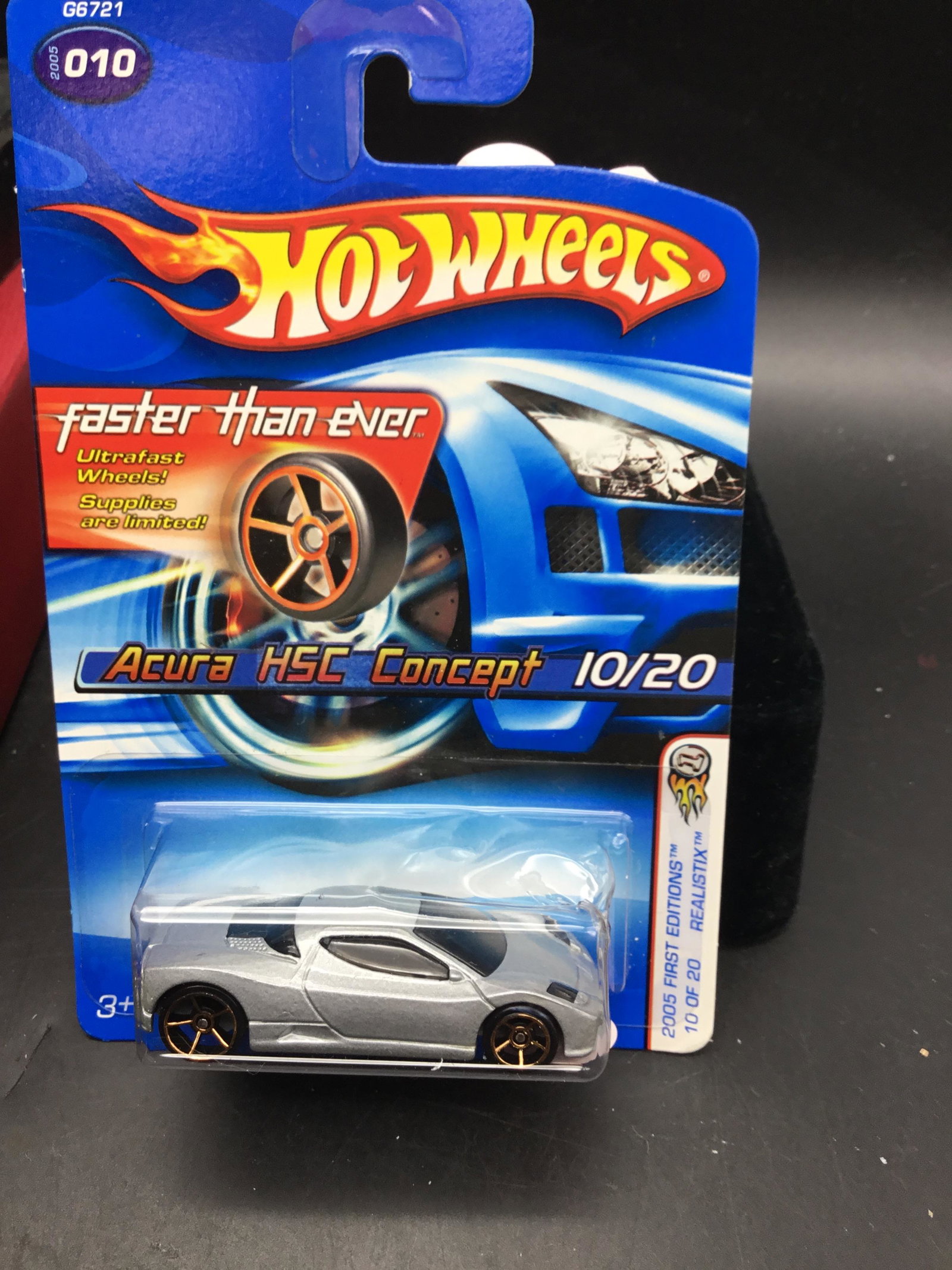 2005 Hot Wheels #010 Acura HSC Concept: 2005 Hot Wheels #010 Acura HSC Concept First Edition with FTE Wheels on grey Malaysia base variation. Has some blister damage.