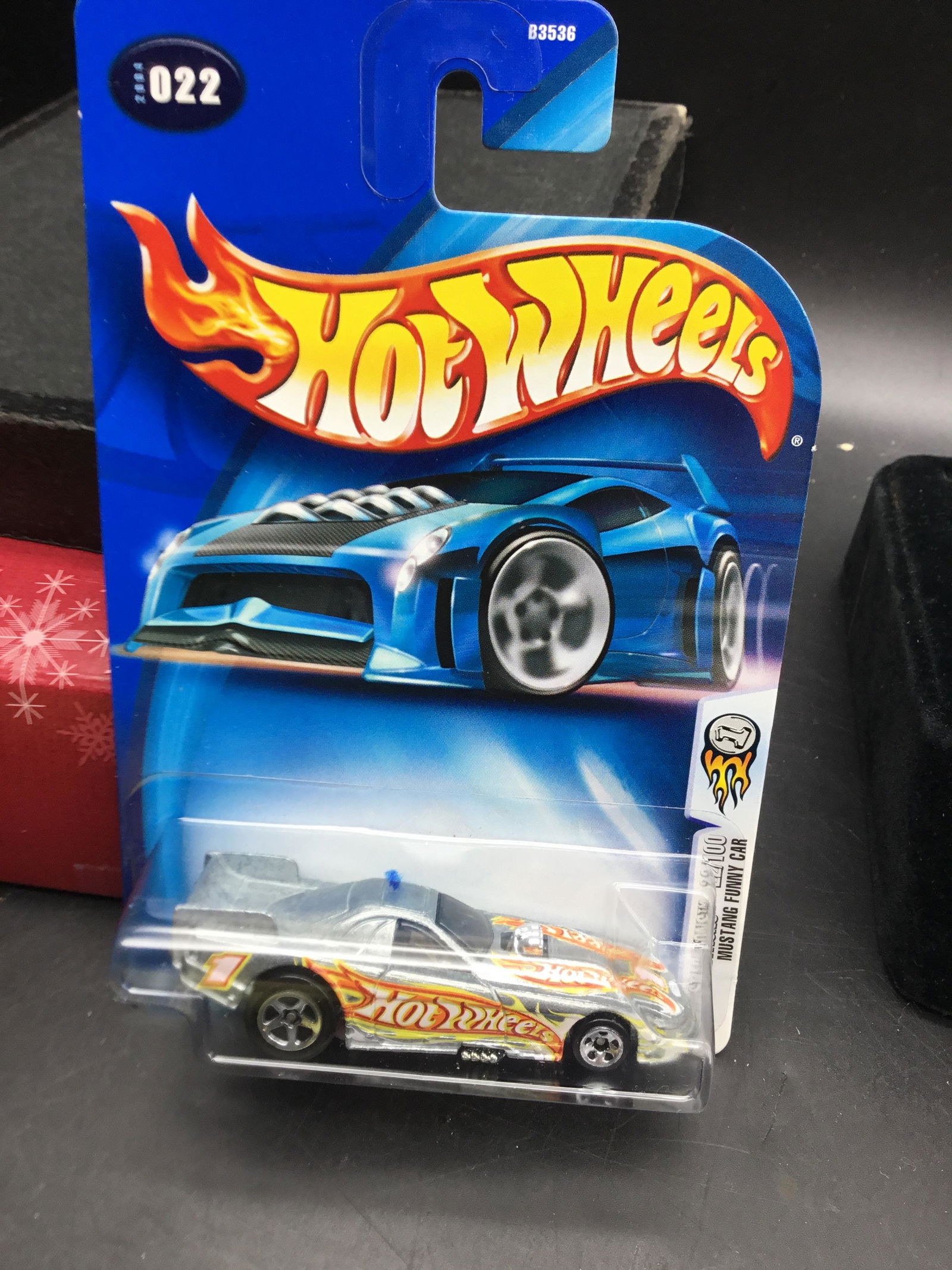 2004 Hot Wheels #022 Mustang Funny Car: 2004 Hot Wheels #022 Mustang Funny Car First Edition Zamac with white Ford oval on front variation. There is also card variation.