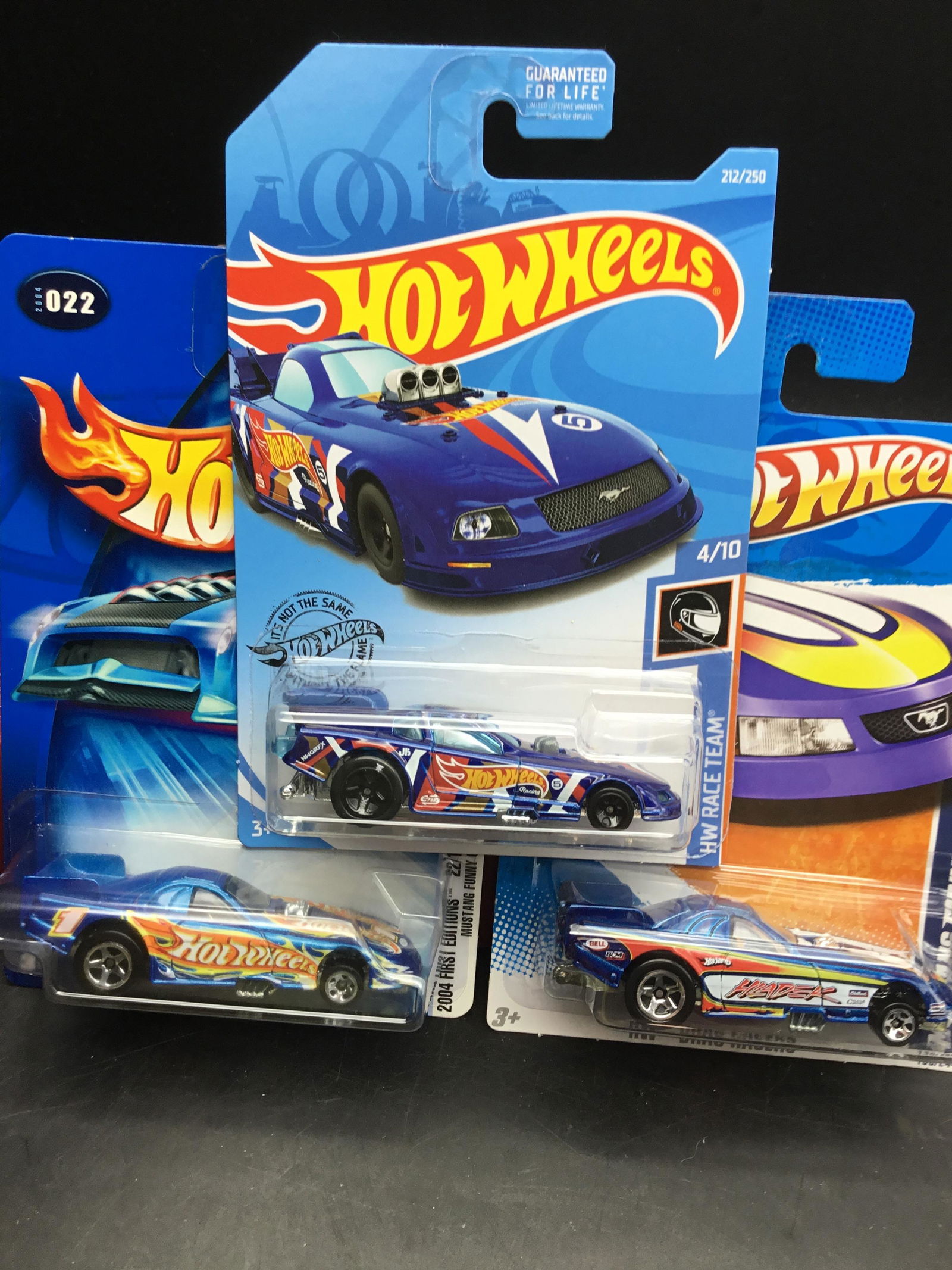 Set of 3 Hot Wheels Mustang Funny Cars: Set of 3 Hot Wheels Mustang Funny Cars set contains #022 of 2004 First Edition with tinted windows variation, #130 of 2011 HW Drag Racers blue metal flake, and #212 of 2019 HW Race Team blue with blac