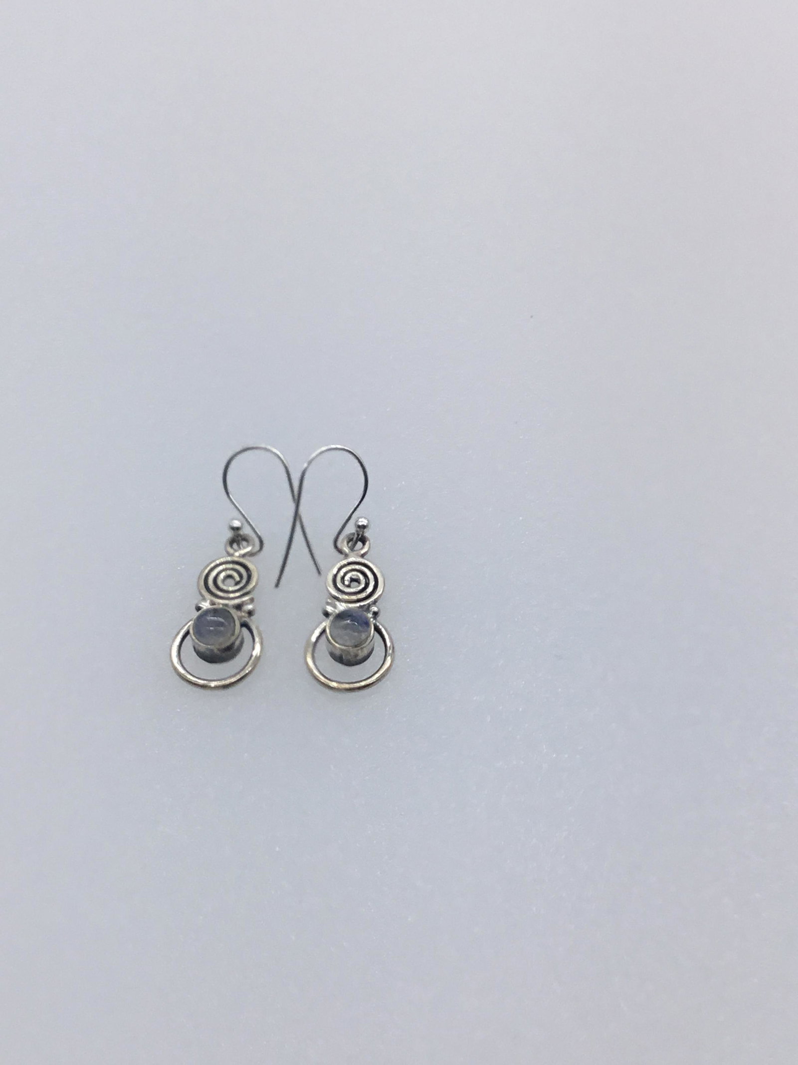 Swirl design earrings with moonstones: Swirl design earrings with moonstones marked 925 weighs 3.3 grams #2202.6
