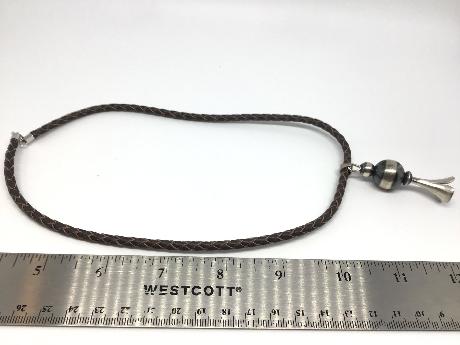 Sterling Silver Squash Blossom necklace: Navajo handmade by Rob Livingston, leatherÊ thong is 16" in length