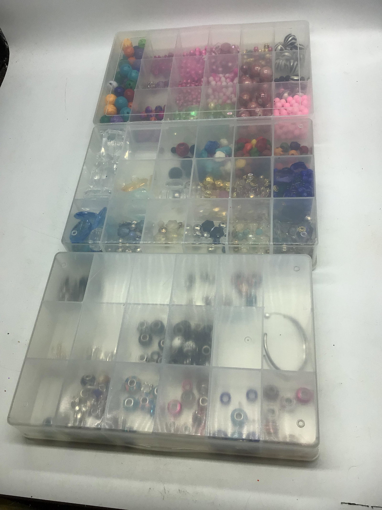 Assorted beads for jewelry making.: Different beads in at least 42 compartments with two bracelets.