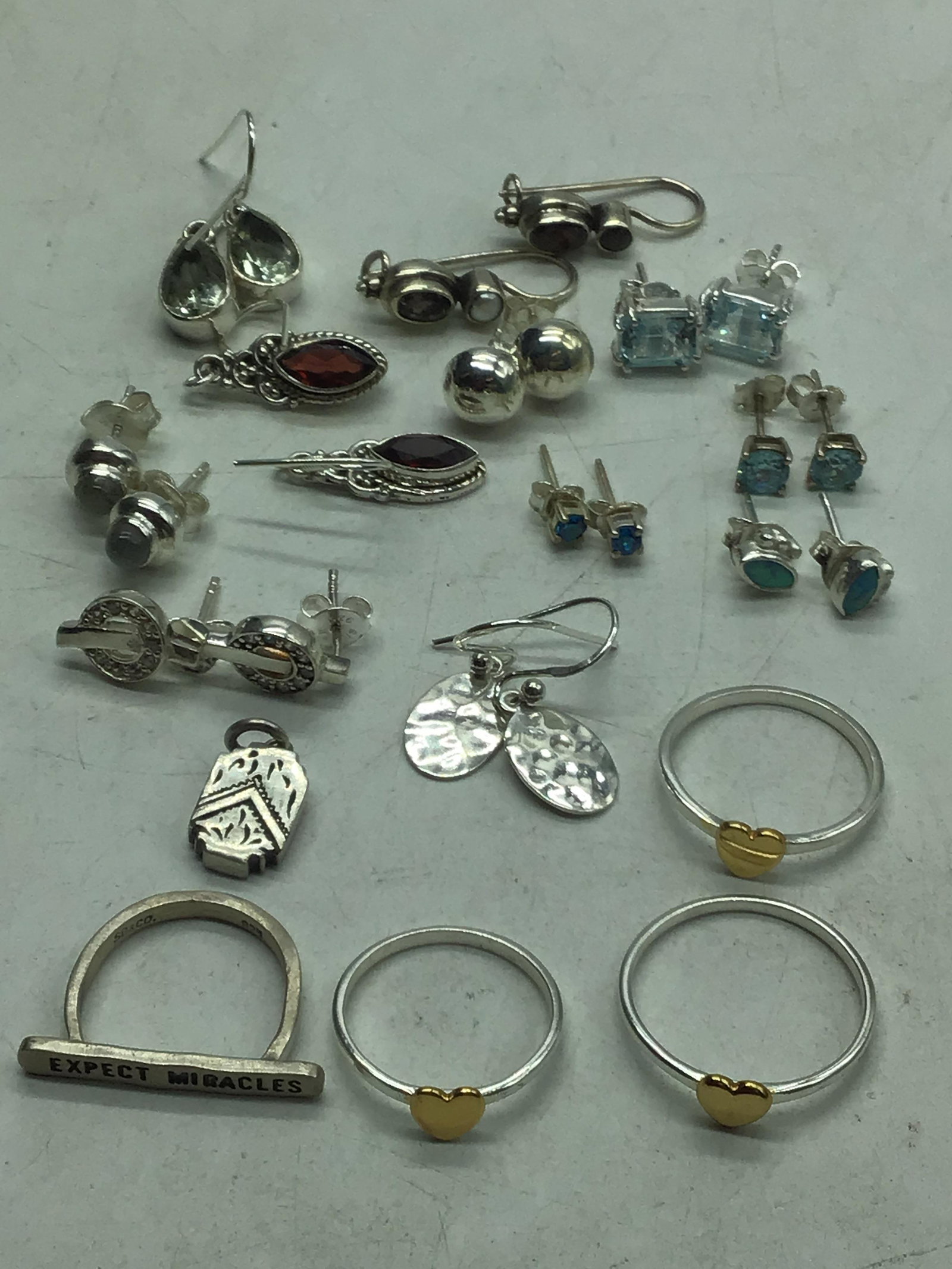 Sterling silver earrings, 1 pendant, and 4 rings. (1 of 3)