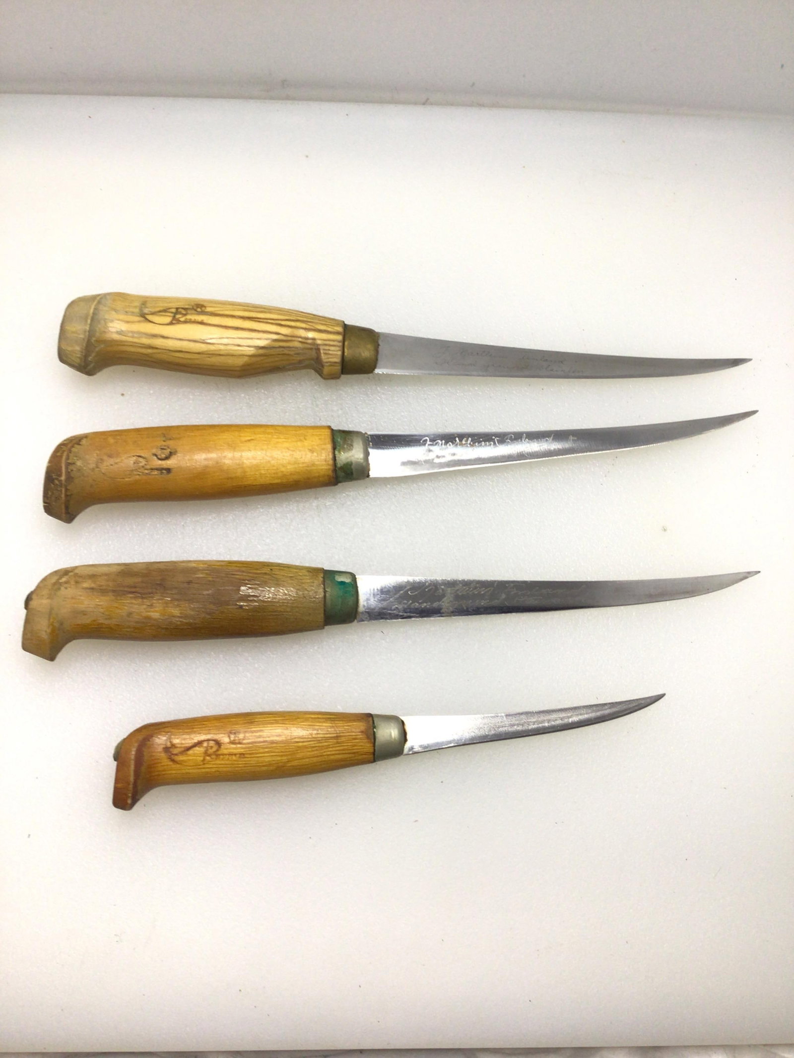 Lot of 4 filleting knives: 4 Rapala filtering knife lot with sheaths.