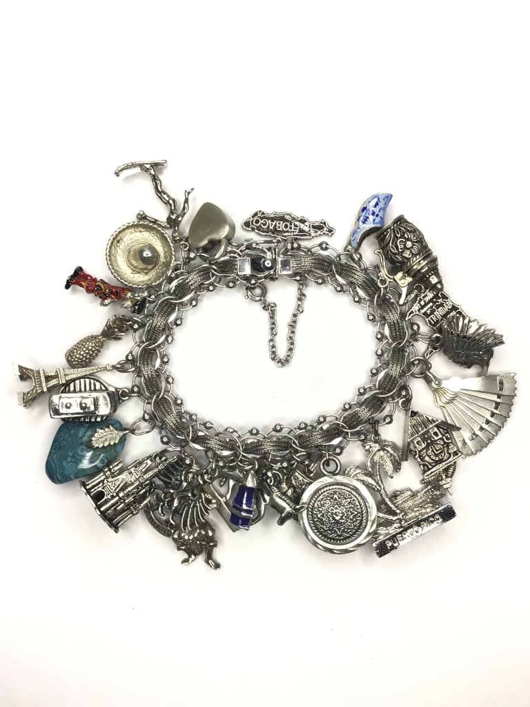 Sterling silver bracelet: Sterling travelers bracelet with over 20 travel stop dangles. 92.92 grams total weight. Approximately 7.5 inches length.
