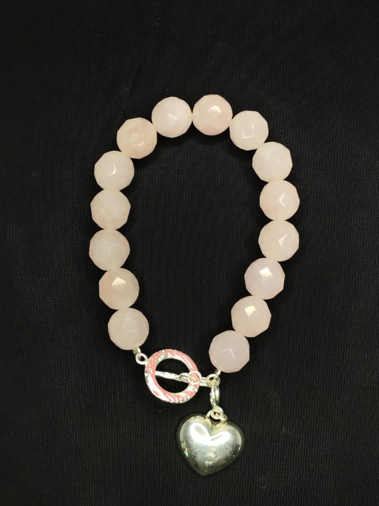 Sterling silver bracelet: Sterling bracelet with rose quartz stones. 38.70 grams total weight. 8 inch length.