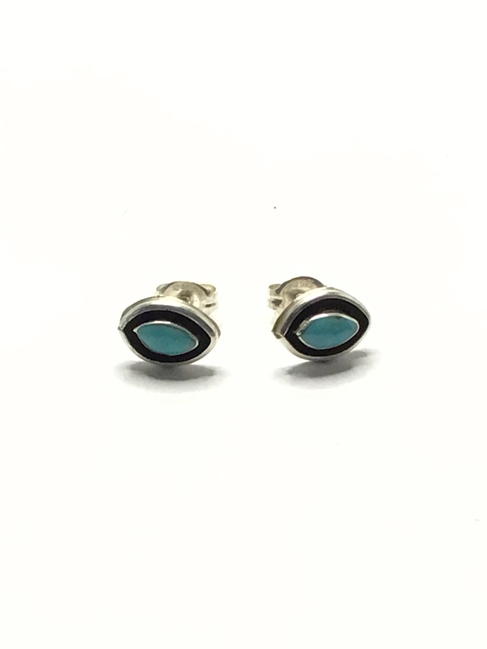 Zuni handmade earrings Sterling silver earrings with turquoise stones. 1.05 grams total weight. Made: Sterling silver earrings with turquoise stones. 1.05 grams total weight. Made by Fred Cachini.