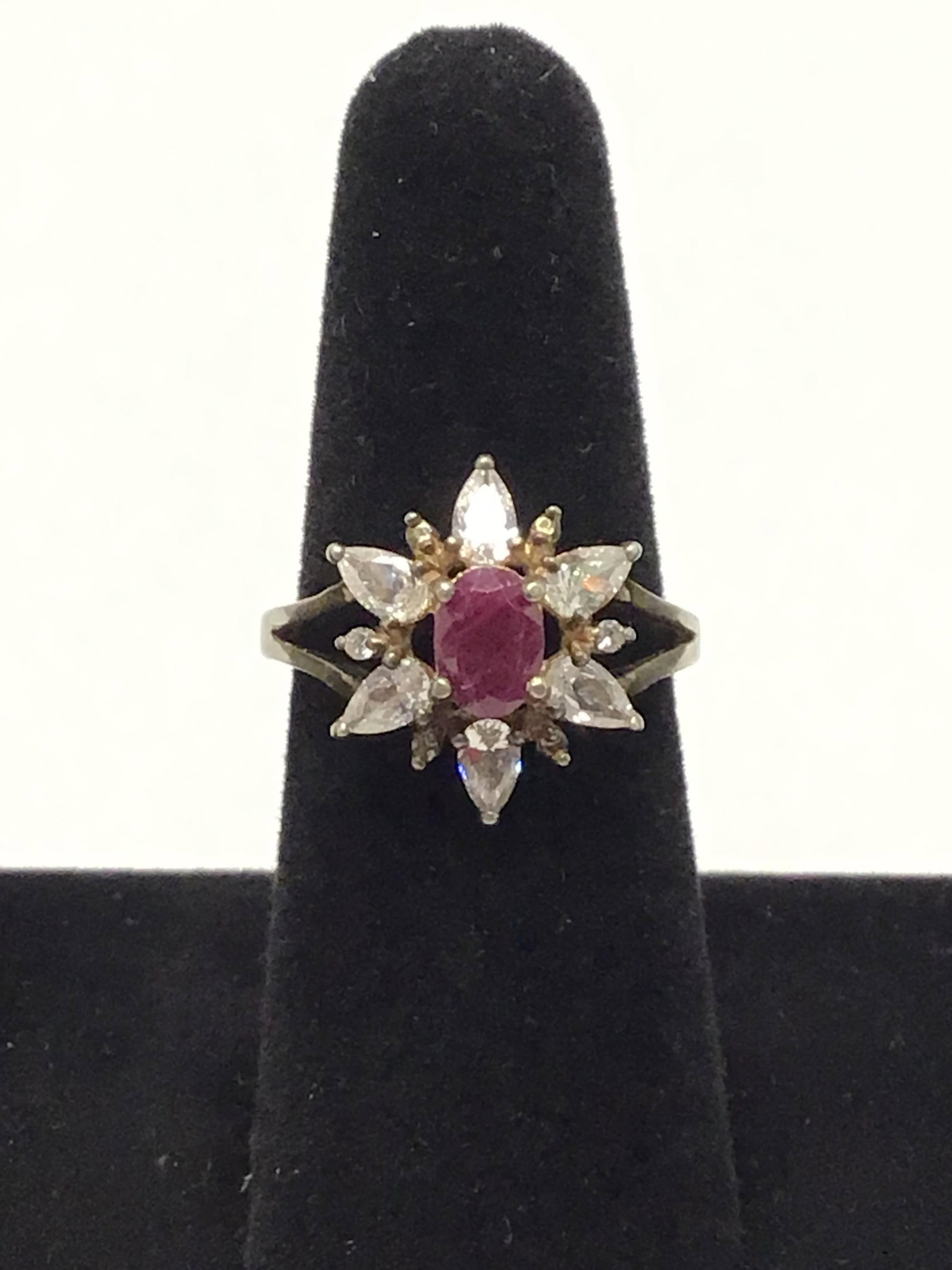 Sterling silver ring: Sterling ring with a ruby plus multiple clear gemstones. 4.61 grams total weight. Size 9 1/2