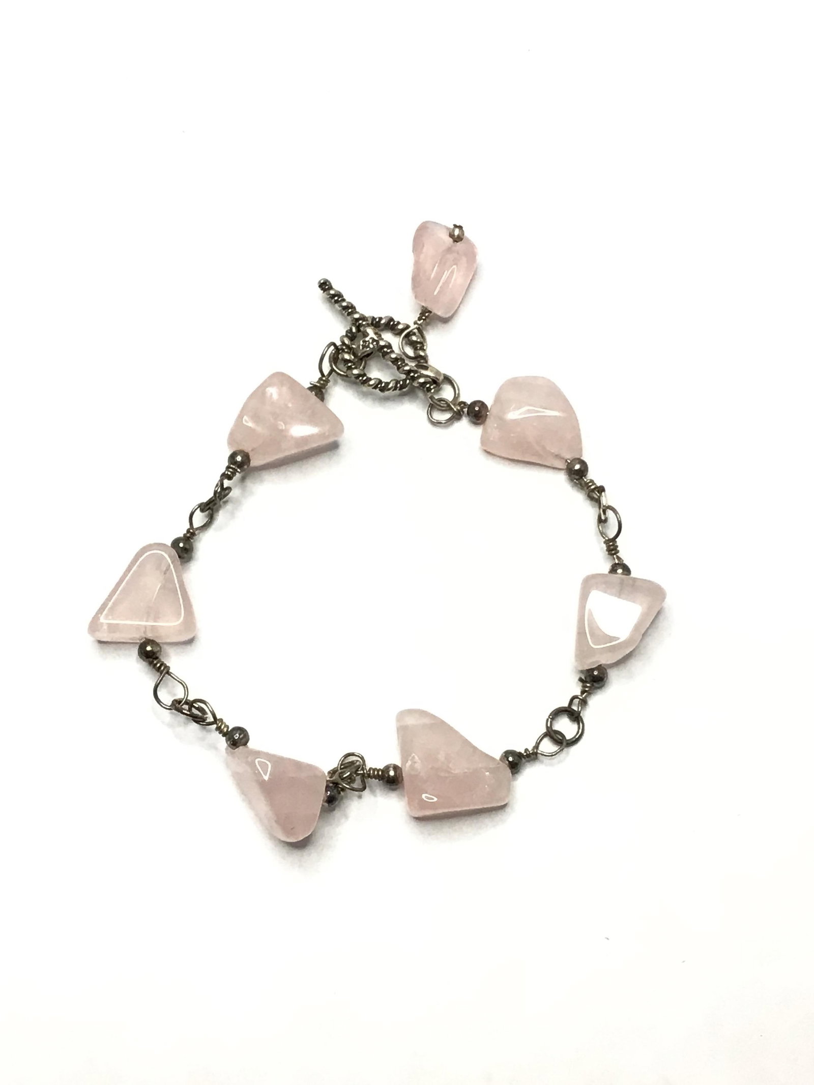 Sterling silver bracelet: Sterling bracelet with rose quartz stones. 14.20 grams total weight. 7.5 inches length.
