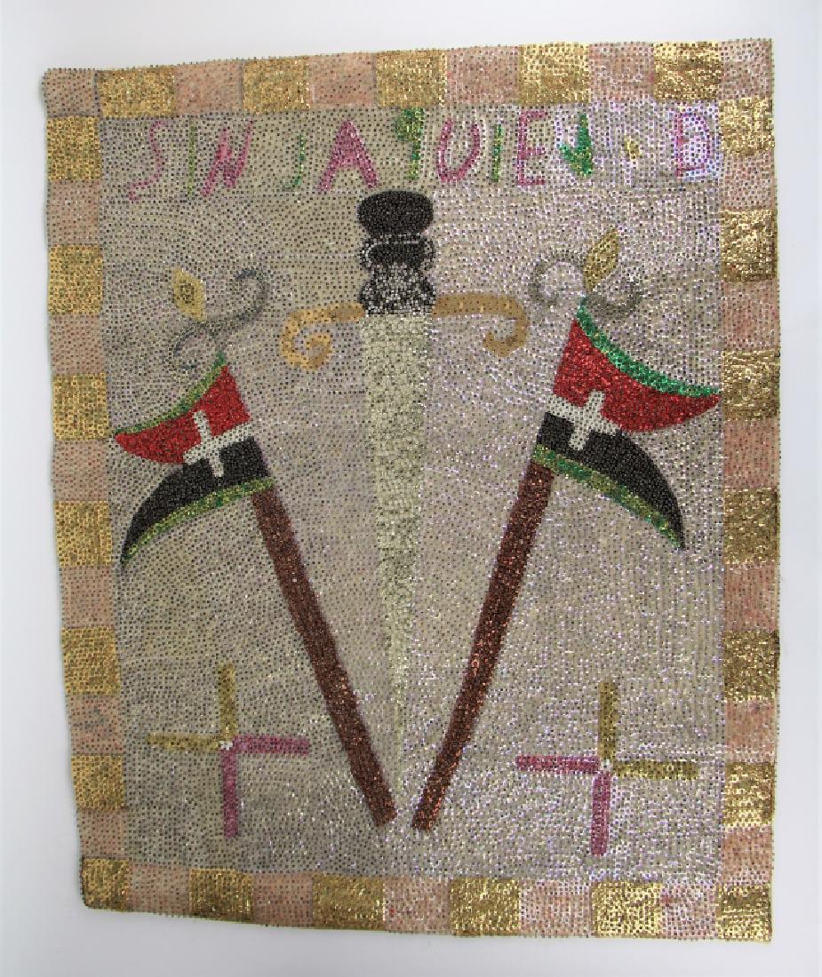 HAITIAN VOODOO SEQUINED DRAPEAU FLAG: Haitian art with writing on the top, depicting sword and flags. With backing. Dimensions 74 x 81 cm (29 x 24 in.). Total approx. weight 750 g. The Estate of Paul Campbell.