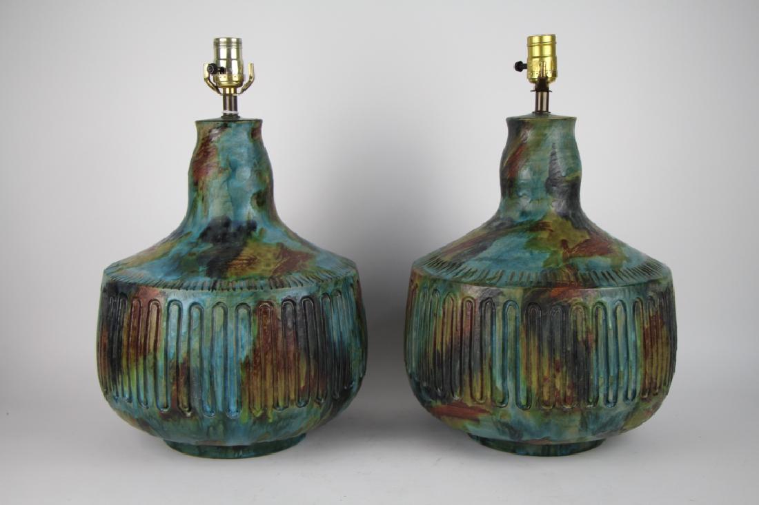 PAIR OF MID-CENTURY POTTERY TABLE LAMPS: In blue green earth tones, possibly Alvino Bagni for Raymor. H. 48 cm (19 in.). Total approx. weight 12.2 kg. The Estate of Paul Campbell.