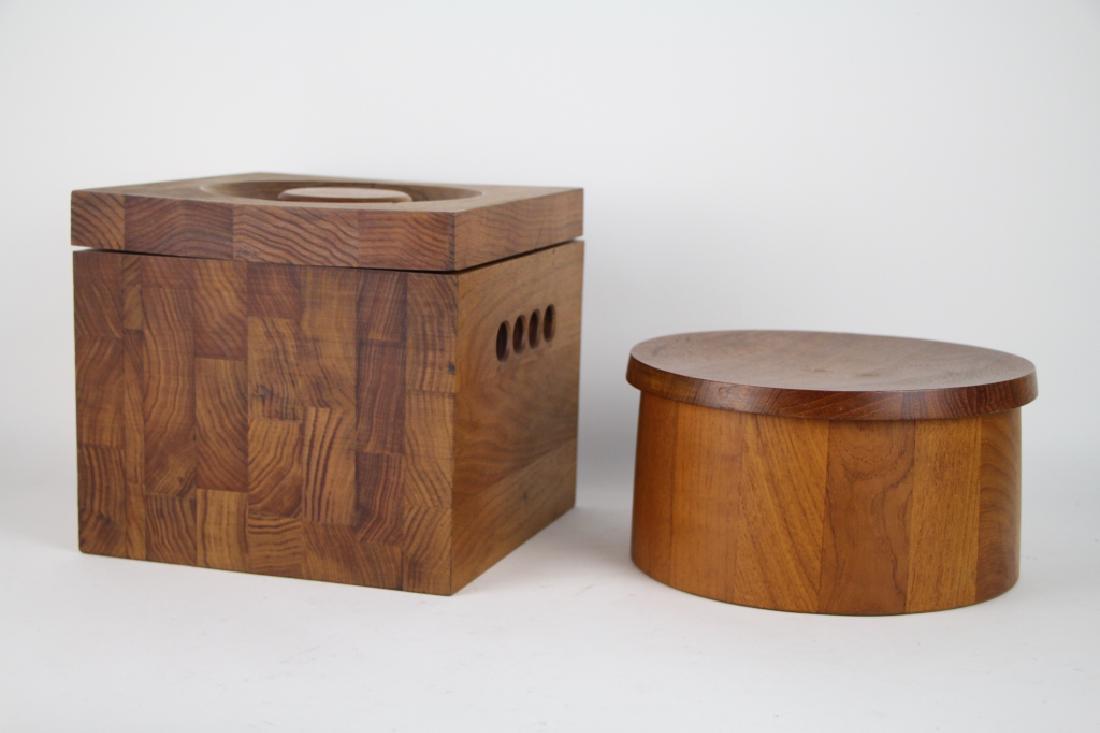 TWO MID CENTURY ICE BUCKETS: Including a round teak ice bucket with black plastic liner by Dansk, and the other having a white plastic liner made by J.K. Adams, W. 23 cm (9 in.). Total approx. weight 3.8 kg.