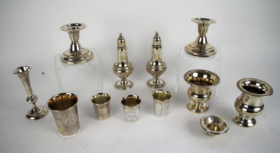 LOT OF ASSORTED SILVER: Including pair of candle holders (weighted), salt and pepper shakers (weighted), bud vase (weighted), toothpick holders, and kiddush cups. H. of tallest 13 cm Total weight approx. (838 g.); 196 g. of