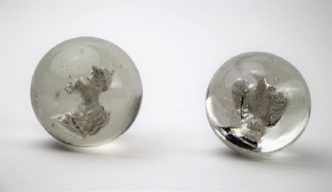 PAIR OF FIGURAL SULPHIDE MARBLES: With bucking horse, no chips or cracks. The other depicting an eagle, as found condition. Dia. of largest (horse) 6cm (2 1/4 in.). Total approx. weight 520g.