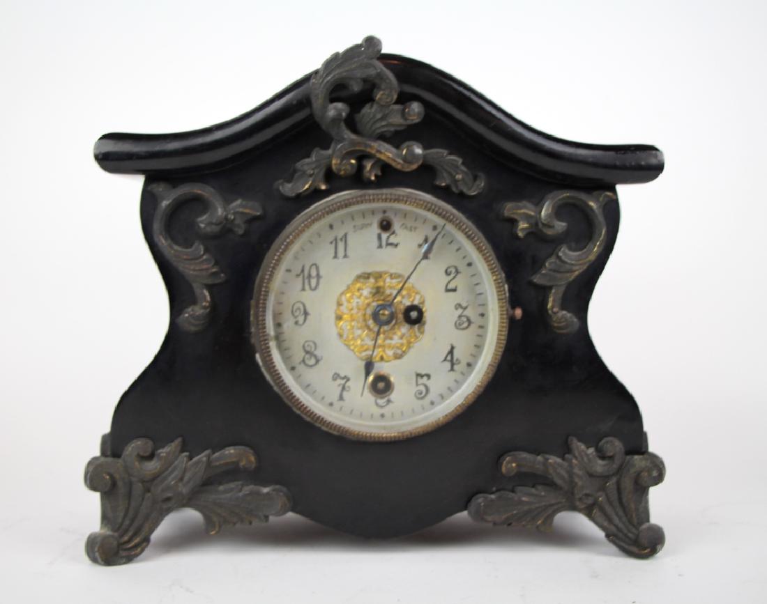 ANTIQUE MANTLE CLOCK: Heavy metal with enamel finish and ornate decoration, with keys and pendulum. H. 21cm (8 1/4 in.). Approx. weight 4.8kg.