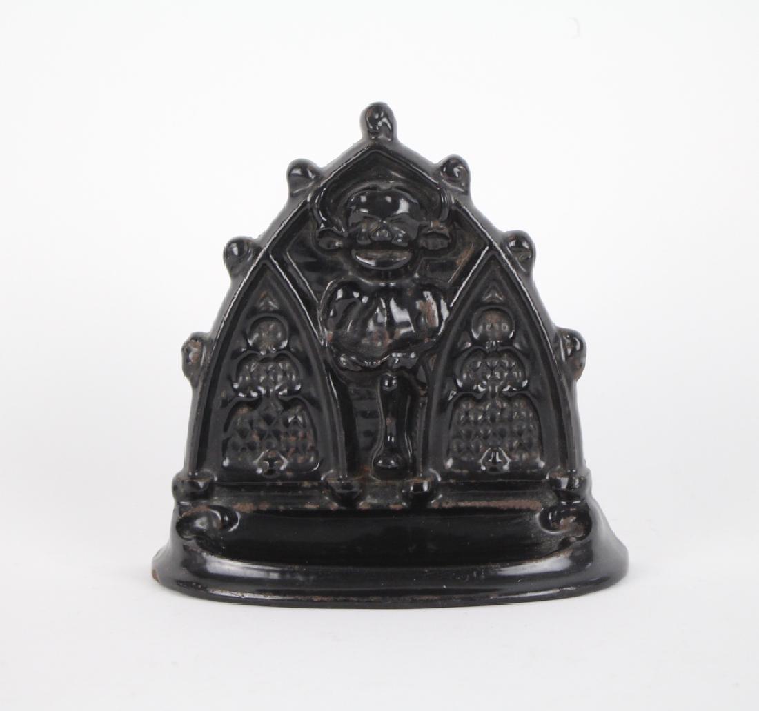 CAST IRON DOOR STOP: Lincoln Imp, inscrition on back. H. 16.5cm (6 1/4 in.). Approx. weight 1.8kg.