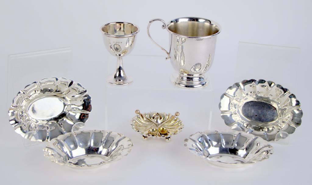 LOT OF SILVER ITEMS: Including hallmarked mug, egg cup and open salt with 2 spoons, together with set of 4 nut dishes. (stamped sterling). Ht. of mug 8 cm. (3 1/4 in.). Total weight 304 g.