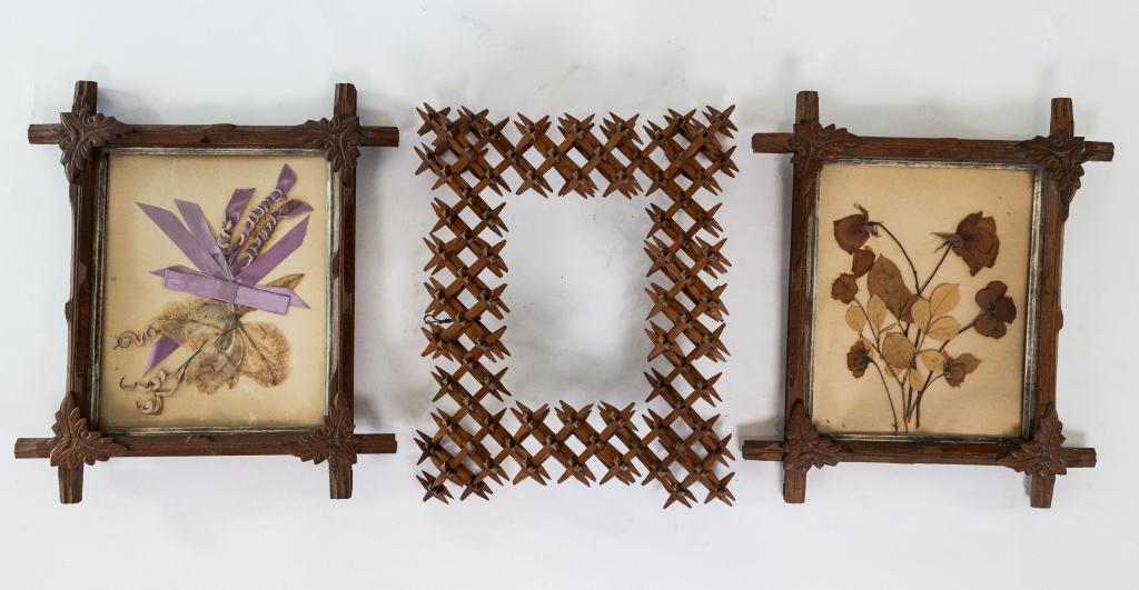 THREE ANTIQUE WOODEN FRAMES: Including a pair of cross bar frames with nature content and one very detailed tramp art frame in thorn style largest 14" x 11"