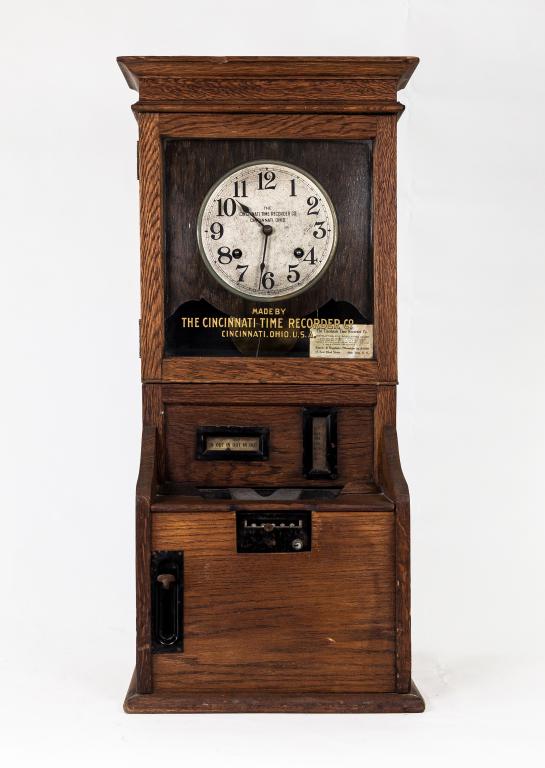 OAK PUNCH CLOCK: Oak case with " Cincinatti time recorder " in gold leaf letters. All clocks are sold as is, with no guarantees of working condition. Size: 38h 16 12d