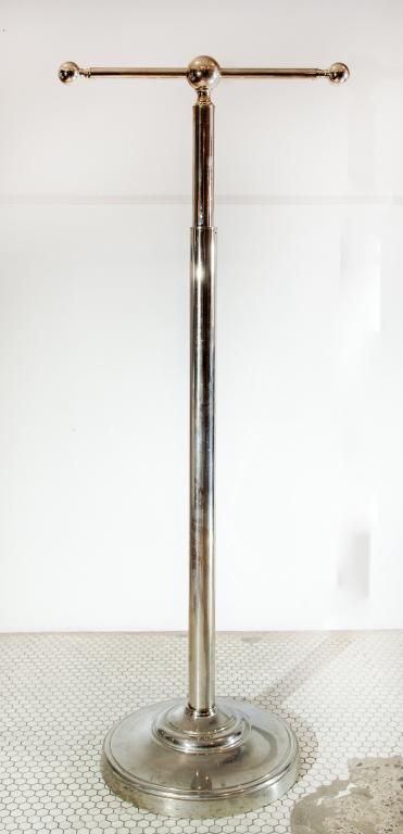 CHROME CLOTHES RACK: Modern design. Quality made chrome clothes rack with cast weighted base. Adjustable Height. Size: 64"h 26d