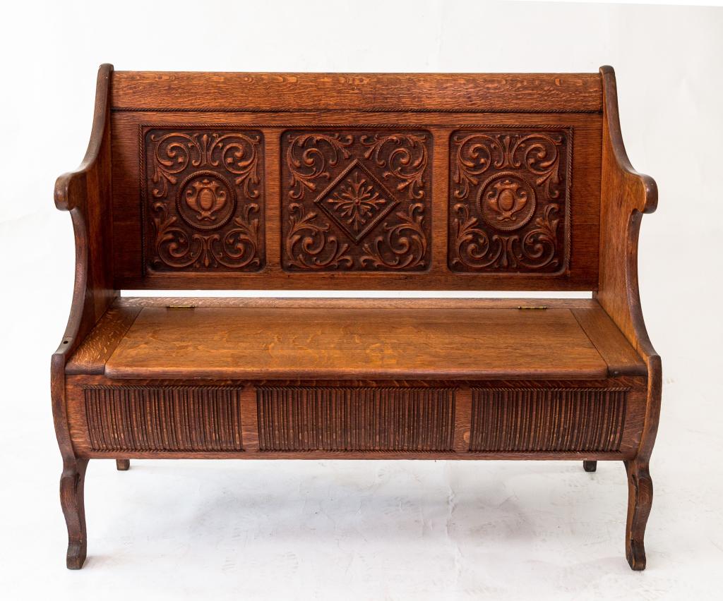 CARVED OAK HALLBENCH: Nicely carved side and back panels with a lift seat for storage. NOTE: repair to one back support. (see photos) Size: 42"h 49w 22d