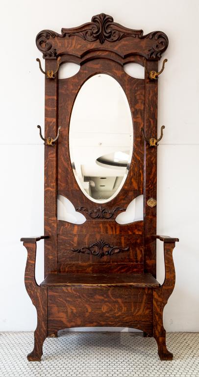 VICTORIAN HALLSTAND: Picture-wood or rolled oak on maple. Lift seat with large oval beveled mirror and cast iron coat/hat hooks. Minor repair to arm and minor wear. (see photos) Size: 88"h 36w 18d