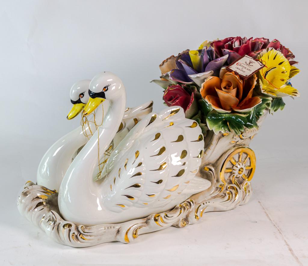 CAPODEMONTE CENTREPIECE: Large and elegant Capodimonte centrepiece depicting 2 swans with a chariot of flowers. Note damage to flowers. Size: 15"h 11w 25d