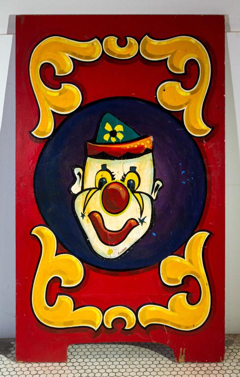 CARNIVAL GAME BOARD: Brightly coloured hand painted carnival game board. Signed, Jim Hand Size: 56.5"h 34w 0.5d