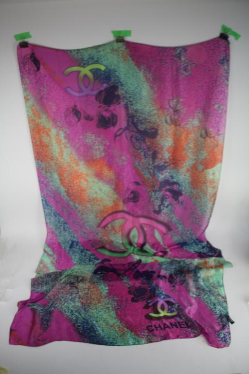 CHANEL AND YVES ST. LAURENT SCARVES: Size of Chanel scarf 34 x 71" and comes with plastic bag. Yves St. Laurent 32 x 32". Total approx. weight 140 g.