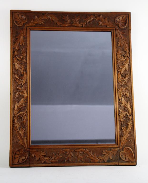 19TH CENTURY HAND CARVED WALNUT FRAME: Beautifully carved frame with mirror having mortise and tenon construction. Size 23 x 18"