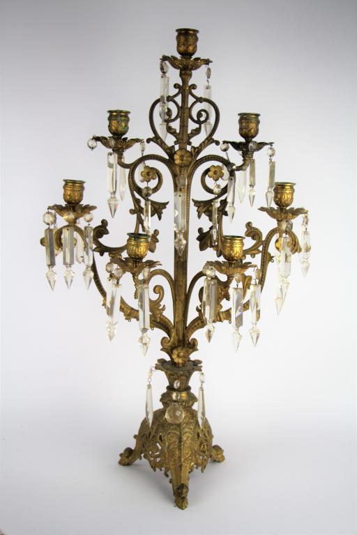 LARGE BRASS CANDELABRA: Seven light candelabra with hanging crystals. With ornate base. Late 19th early 20th century. NOTE: Some chips to crystals no guarantee