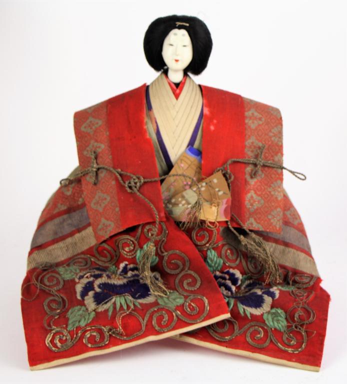 JAPANESE HINAMATSURI EMPRESS DOLL: With elaborate embroidered clothing. Probably straw filled, with gofun over wood head. Appears to be signed on base. Comes with small stand. Probably purchased at Holt Renfrew. From the collections of