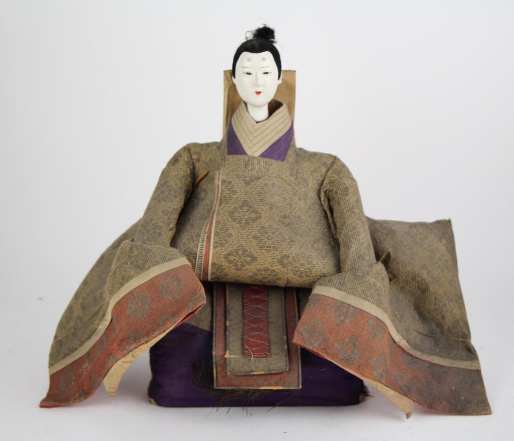 JAPANESE HINAMATSURI EMPEROR DOLL: Straw filled, with gofun on wood head. NOTE: Minor cracks- one near mouth and one at side and two at the back (see photos.) Probably purchased at Holt Renfrew. From the collections of Paul Duval. Ht.