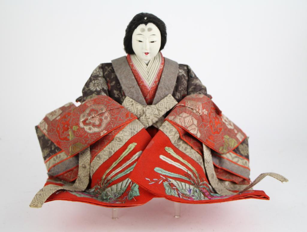 JAPANESE HINAMATSURI EMPRESS DOLL: With elaborate embroidered clothing. Probably straw filled, with gofun over wood head. Comes with small plastic stand. NOTE: Light cracking on face (see photos.) Probably purchased at Holt Renfrew. Fr