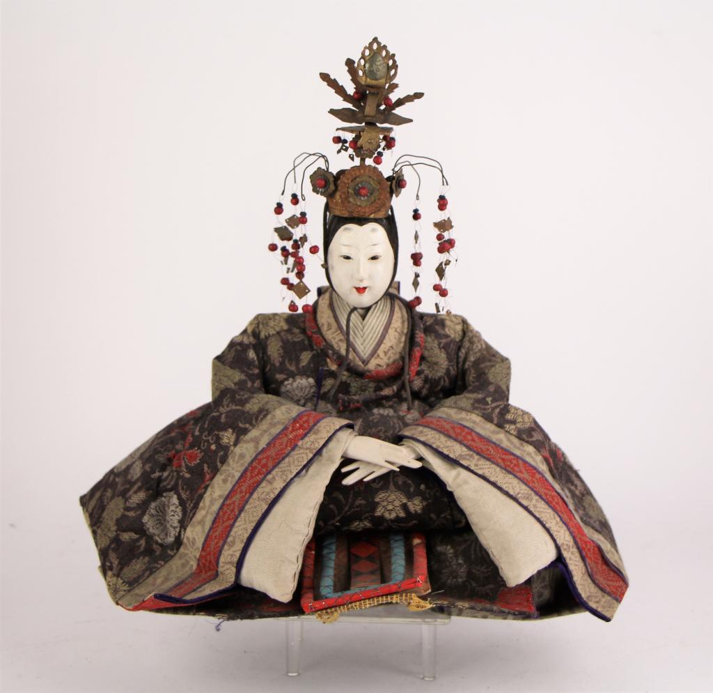 JAPANESE HINAMATSURI EMPRESS DOLL: With elaborate metal headdress, tapestry kimono. NOTE: Slight cracking on head (see photos.) Probably purchased at Holt Renfrew. From the collections of Paul Duval. Lt. 33 cm. (13 in.) Approx. weight: