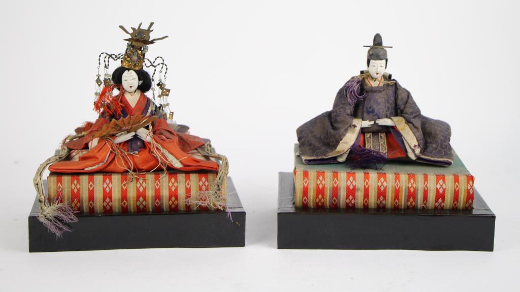 HINAMATSURI EMPEROR AND EMPRESS: In elaborate clothing, circa early 19th c. On lacquer stands. Woman has small fan with Holt Renfrew label. From the collections of Paul Duval. Ht. with stand 20 cm. (8 in.) Total approx. weight: 350 g