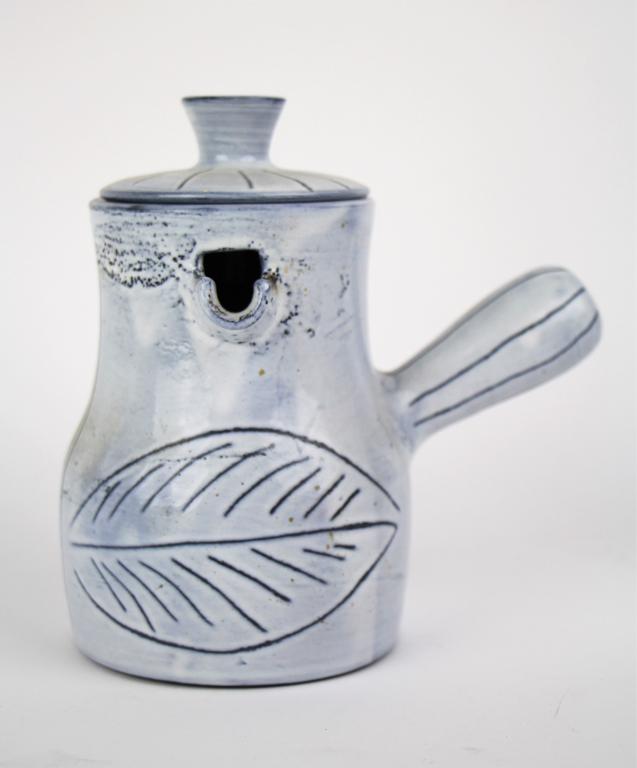 JACQUES INNOCENTI MID-CENTURY POTTERY JUG: Jacques Innocenti, Vallauris France studio pottery jug with lid. Having leaf decoration. Ht. 18 cm. ( 7 in.). Approx. weight 600 g.
