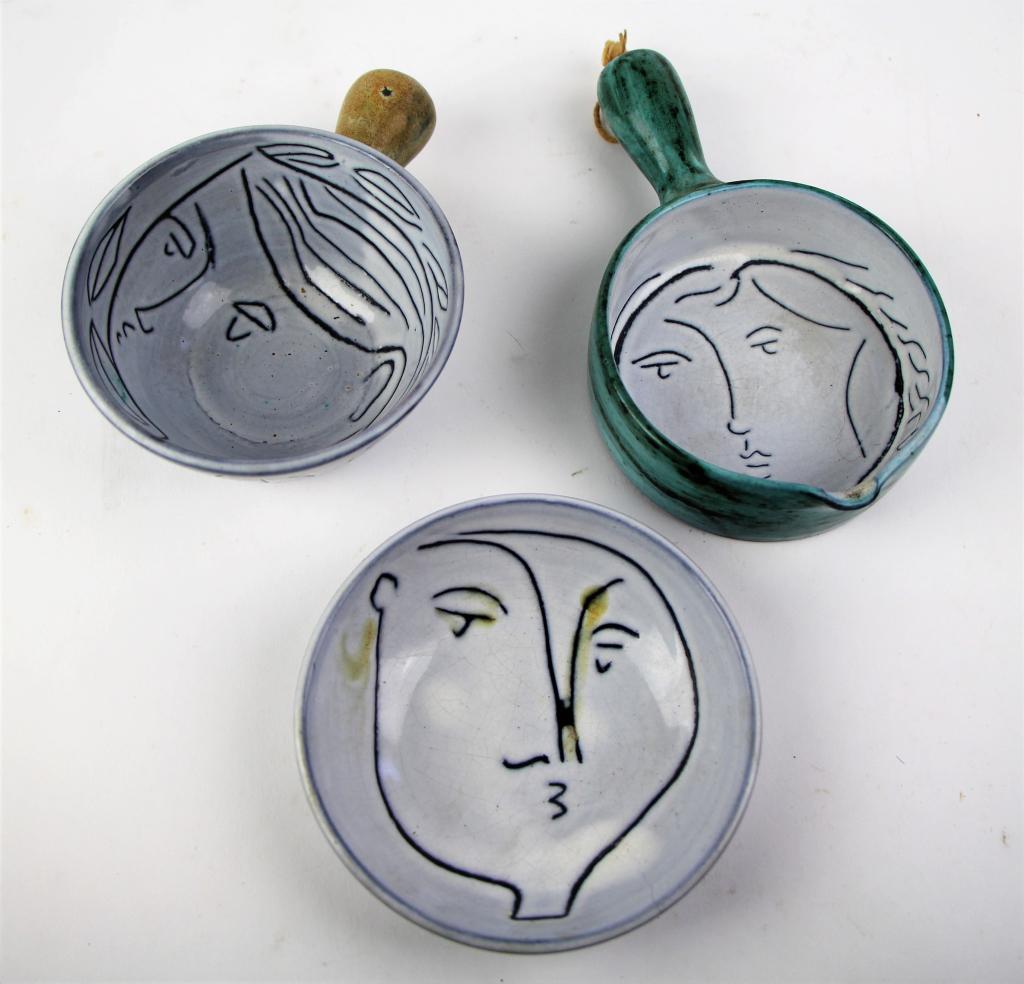 THREE PIECES OF JACQUES INNOCENTI STUDIO POTTERY: Jacques Innocenti, Vallauris France mid-century pottery including 2 handled bowls and small bowl, all with face decoration. NOTE: some discolouration to one piece (in glaze). Length of longest 16 cm.