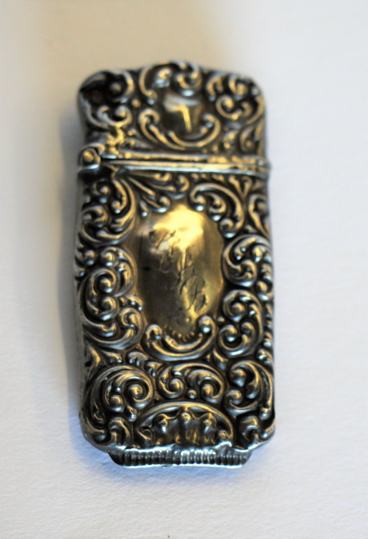 SMALL SILVER MATCH SAFE: With ornate decoration, ingraved monogram, stamped sterling. Ht. 2 1/2"